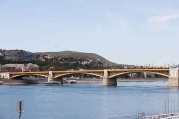 Fototapeta premium Long walking bridge over the Danube. The capital of Hungary is Budapest. Sunny weather for a walk around the big city.