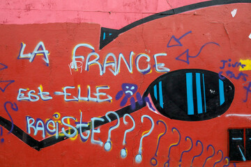 Street wall covered with street art and graffiti in Paris, France. 