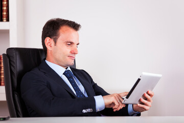a businessman seamlessly integrates technology into his routine, expertly navigating a tablet - 727073847
