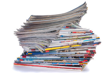 Pile of old paper magazines isolated on white background