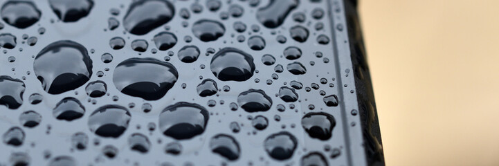 Schwarzes Elektrisches Gerät mit dicken glänzenden Regen-Tropfen in voller Schönheit auf dem...