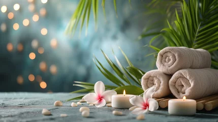 Fototapete Rund Spa background. Beauty day spa salon background with rolled towels, lit candles, palm leaves and plumeria frangipani flowers, and smooth spa massage stone pebbles. Relaxation spa template © Ron Dale