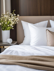 Modern hotel room with a neatly made bed, plush pillows, and elegant scandinavian simple decor.