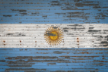 Close-up of old metal wall with national flag of Argentina . Concept of Argentina export-import, storage of goods and national delivery of goods. Flag in grunge style