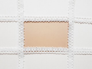 White lace tape on white canvas with brown blank center.