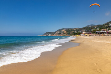 Paraglider soaring above Kleopatra Beach Alanya Turkey