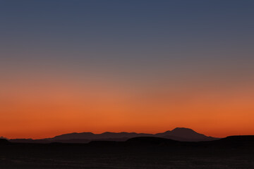 Beautiful colorful sunset sky landscape in desert with distant mountains, Egypt