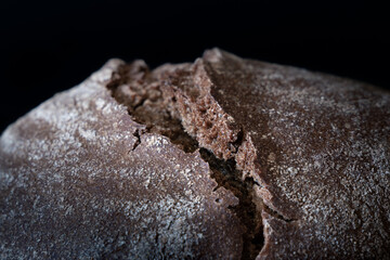 Abstract macro shot of loaf of brown bread with break on top like canyon in mountains