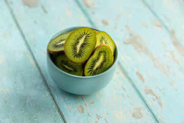 kiwi bowl close up with rustic blue table