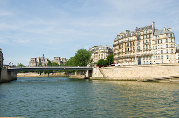 Travel in summer on a river boat along the Seine River in the center of Paris and see the sights, buildings and bridges
