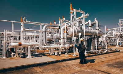 Male worker inspection exchanger afternoon of tank oil refinery pipeline plant steam vessel and...