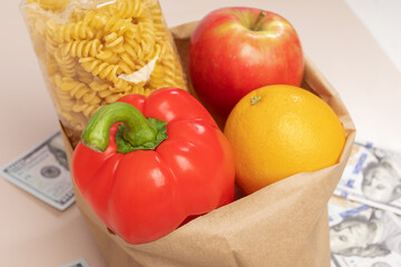 Grocery bag with food and money, cost-saving measures, budget-friendly shopping, financial planning