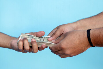 Hand Giving Indian 500 Rupee Bank Notes. concept for earnings or spend in Agriculture.