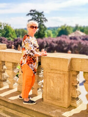 Senior woman on excursion in Troja Palace is a Baroque palace located in Troja, - obrazy, fototapety, plakaty