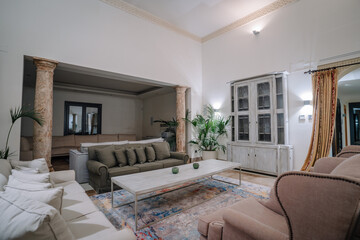 Sotogrante, Spain - January 27, 2024 - An elegantly decorated living room with sofas, a glass...