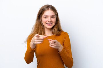 Teenager Russian girl isolated on white background surprised and pointing front
