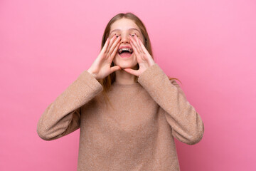 Teenager Russian girl isolated on pink background shouting and announcing something