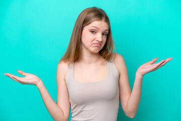 Fototapeta premium Teenager Russian girl isolated on blue background having doubts while raising hands