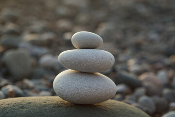 Fototapeta na wymiar Pyramid of pebbles on the beach, zen, harmony and balance concept