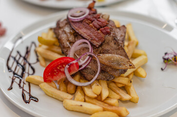 Dish of meat and French fries