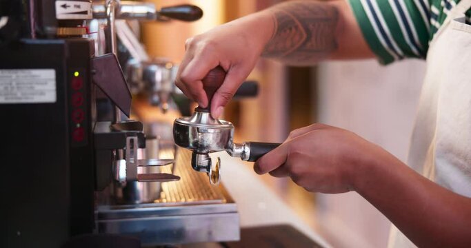 Hands, coffee grinder and barista at machine in cafe, process and professional service in small business. Closeup, ground and waiter prepare espresso drink, portafilter or cappuccino beverage in shop