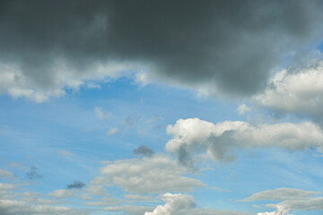 Obraz premium A terrible black cloud hangs in the sky before the rain. Bad weather. Hurricane and thunder over the city. Climate change and natural disasters. Bad mood and despondency.