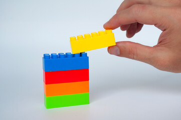 Plastic building-block toys on white cover background. Childhood toy concept
