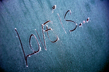 text love is on a Winter frozen  car window, texture freezing ice glass background, - 727142287