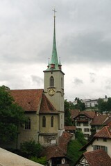 Fototapeta na wymiar View of church and rooftops in Bern, Switzerland