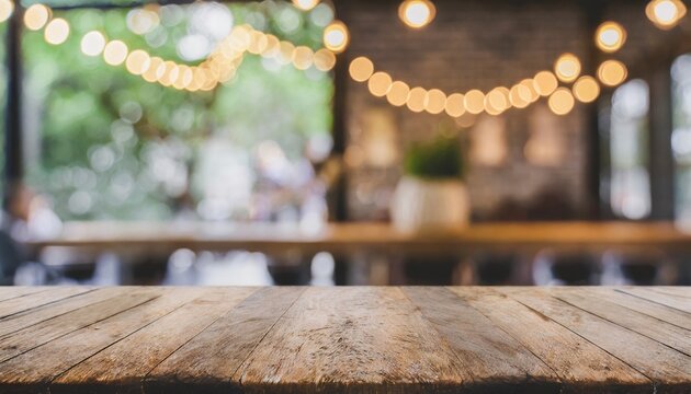 empty old wood table top and blurred bokeh cafe and coffee shop interior background with vintage filter can used for display or montage your products