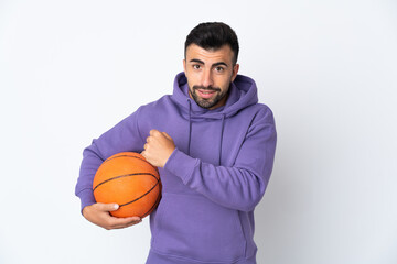 Man playing basketball over isolated white wall celebrating a victory