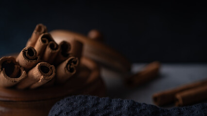 Cinnamon sticks on a black background. Selective focus. 