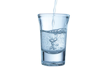 Image of pouring drinking water into a clear glass with bubbles on a white background.