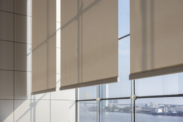 white curtain or white blinds Roller sun protection in office with river view background.
