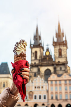 Female hand is holding traditional czech cookie trdelnik in Prague.