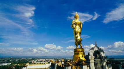 Buddha statue, Buddha standing on a mountainat Wat Phra That Khao Noi in Nan, Thailand. Golden...