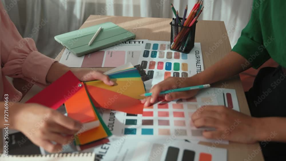 Poster slow motion hand closeup of two designer brainstorming and choosing color for graphic design working