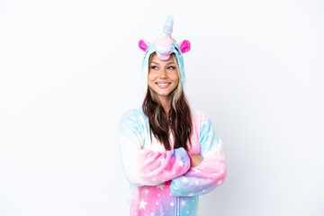 Obraz na płótnie Canvas Young Russian woman wearing a unicorn pajama isolated on white background with arms crossed and happy