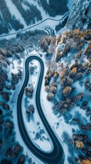 Aerial view of the winding Snake Road in winter in the Dolomite Alps of Italy