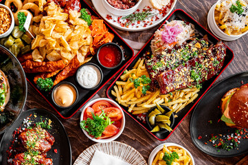 variety of restaurant food dishes on table. top view.
