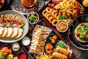 variety of restaurant food dishes on table. top view.