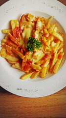 Homemade Poutine; French fries covered in sauce and cheese