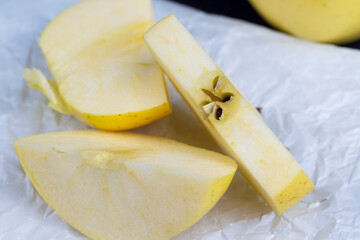 yellow ripe apple with cinnamon on the table