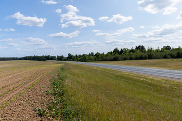paved road along and blue sky
