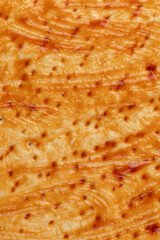 pizza dough with red ketchup and spices