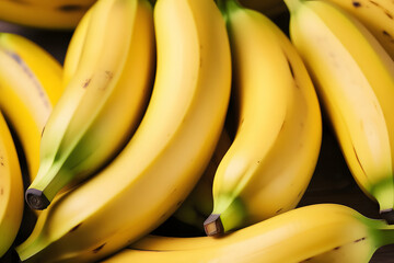 A close-up image of a bunch of ripe, yellow bananas.