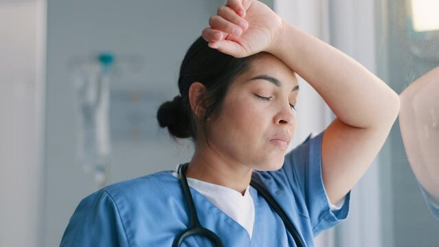 Woman, nurse and stress by window at hospital in depression for mistake, fatigue or mental health. Face of frustrated female person, scrub or medical employee looking out glass in anxiety at clinic