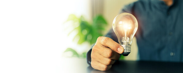 Close up hand choose light bulb or lamp with bright for human resources or leadership and creativity thinking idea motivation or vision and knowledge learning.
