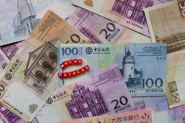 Stack of Macao Money Patacas With Red Cubes