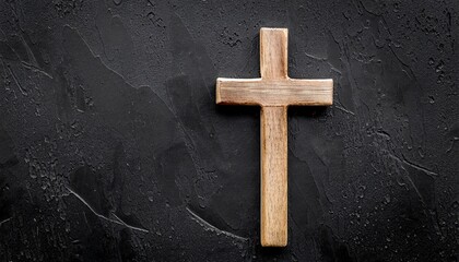 funeral concept wooden cross on black background top view copy space